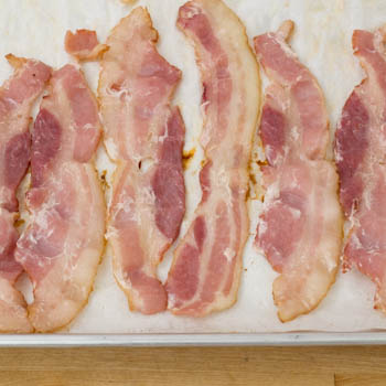 cooked bacon on a baking tray