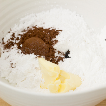 combining icing sugar, margarine, and cocoa