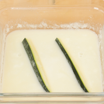 dipping zucchini into wet mixture