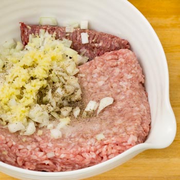 beef, pork, margarine, and other meatball ingredients combined in a bowl