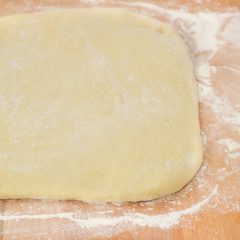 Dough on a floured board.