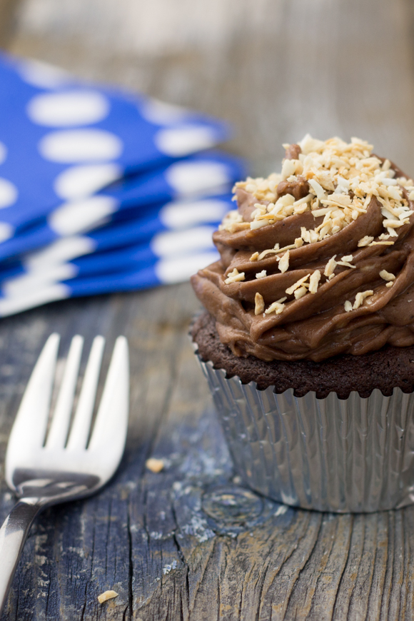 frosted cupcake with toasted coconut sprinkled on top