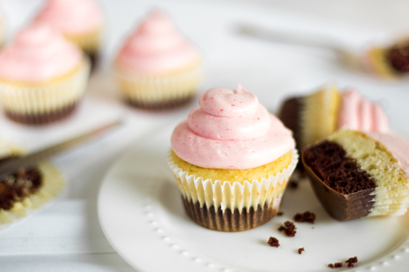 Neapolitan cupcakes sitting on a plate.