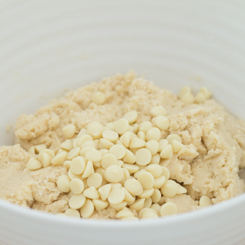snickerdoodle cookie dough in a bowl with white chocolate chips