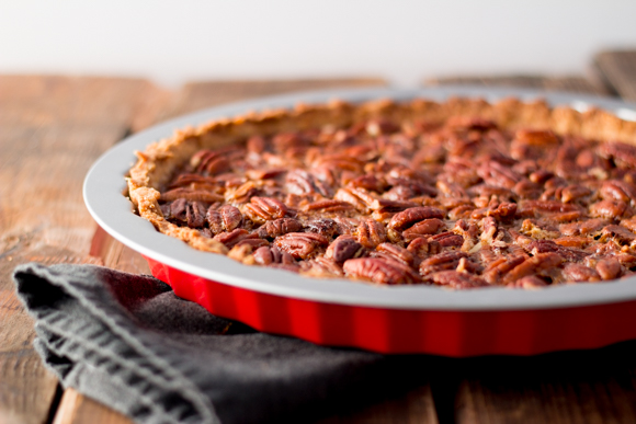 A beautifully baked Maple pecan tart in a red pie form